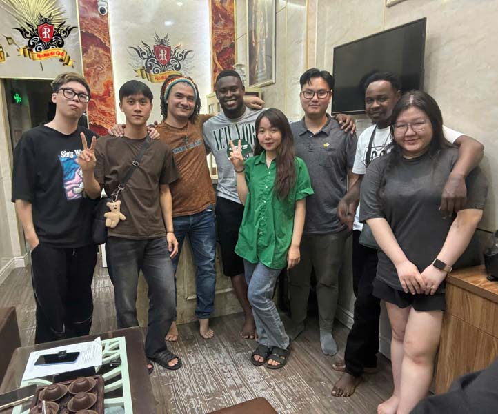 International tourists visiting Master Artist Trieu Viet Anh in Hanoi for world-class tattoos at affordable prices.