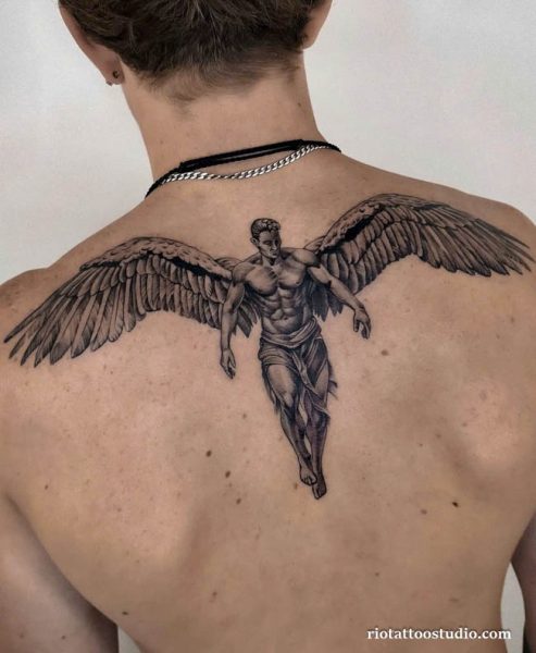 Elegant angel tattoo with wings and swirls on shoulder, graceful guardian angel tattoo