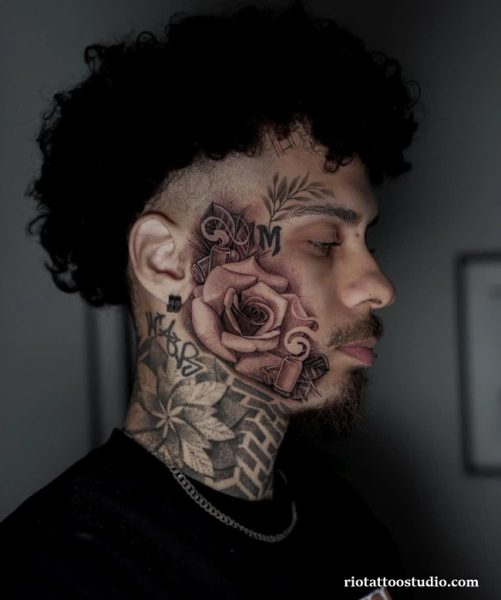 Geometric rose face tattoo with initials patterns on side head, cool bold face tattoo