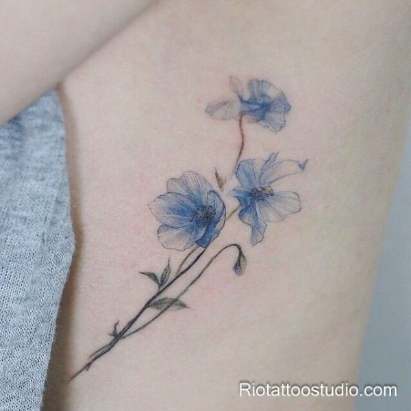 Red carnation flowers with green leaves on forearm, feminine watercolor tattoo
