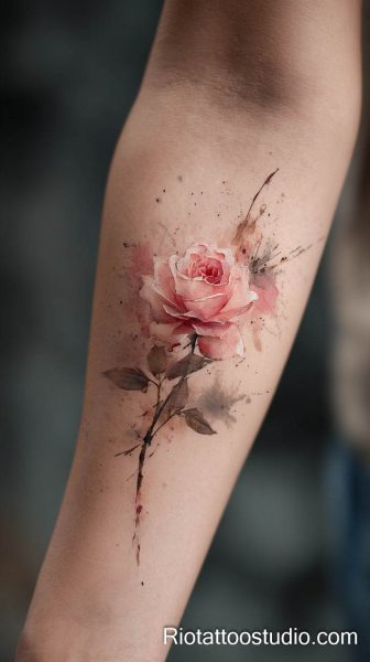 Pink bougainvillea flowers and green leaves on forearm, feminine watercolor floral tattoo