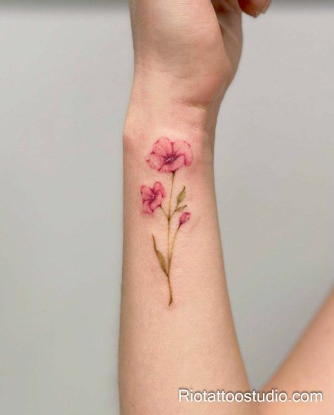 Pink cosmos flowers with delicate butterfly on forearm, feminine watercolor flower tattoo