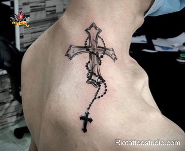 Neck cross tattoo with flowing rosary beads and small pendant crucifix, realistic black ink shading on upper neck/back, spiritual cross tattoos symbolizing prayer and devotion