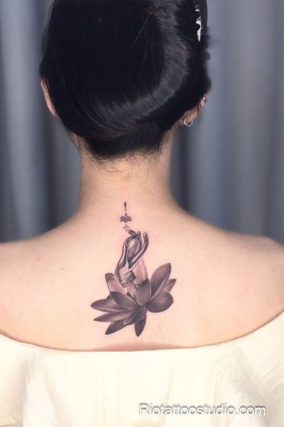 Lotus flower tattoo with meditating hands and star on neck back, spiritual lotus tattoo