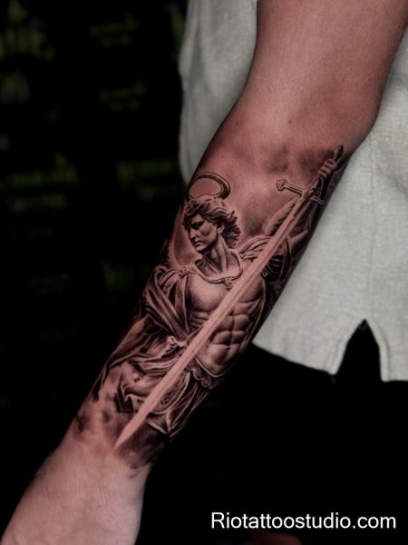 Archangel michael tattoo with halo sword and sun rays on arm, radiant divine tattoo