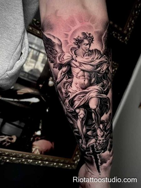 Michael archangel tattoo with sword crushing demon on leg, powerful divine tattoo