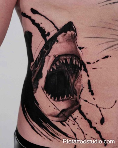 Great white shark jaws face tattoo on chest rib with black slashes, intense realistic shark tattoo