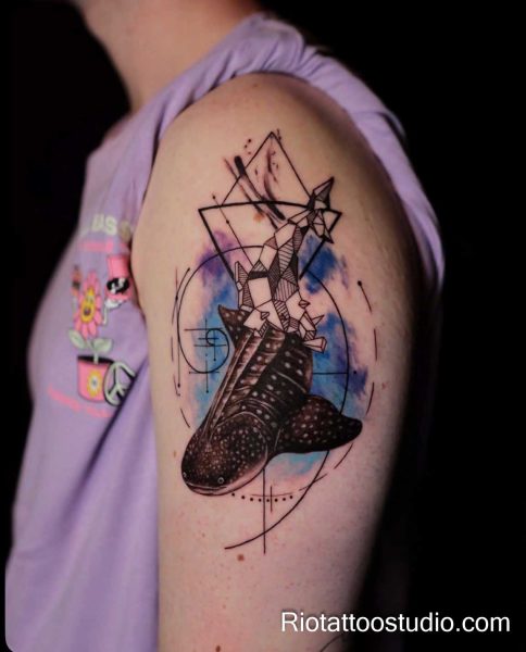 Geometric whale shark tattoo with watercolor and shapes on shoulder, artistic shark tattoo