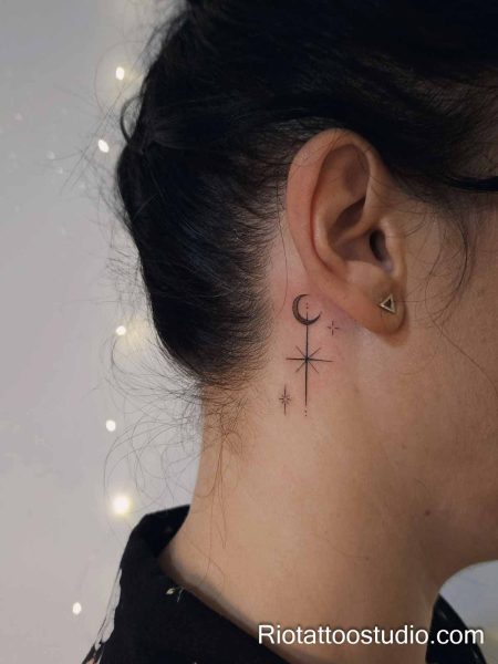Tiny moon and star constellation behind the ear, minimalist behind-the-ear tattoo