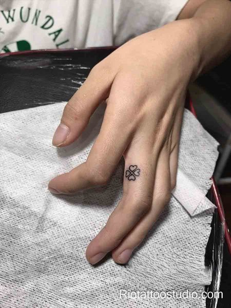 Smallest tattoos: micro finger symbols flower leaf sun heart on finger, tiny colorful tattoo