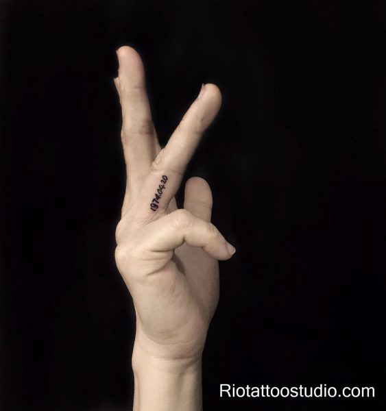 Micro finger date tattoo 1974.04.20 on finger, personal tiny tattoo
