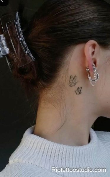 Smallest tattoos: two tiny butterflies behind the ear, feminine behind-the-ear tattoo