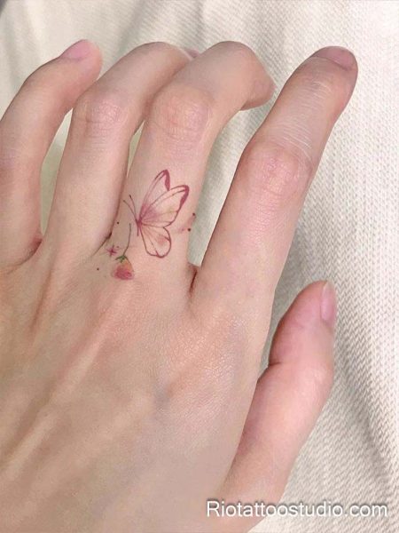 Micro finger watercolor butterfly and strawberry on finger, feminine tiny tattoo