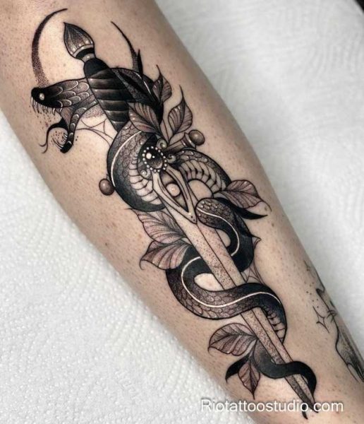 Snake dagger tattoo with leaves eyes abstract on forearm, detailed snake tattoo