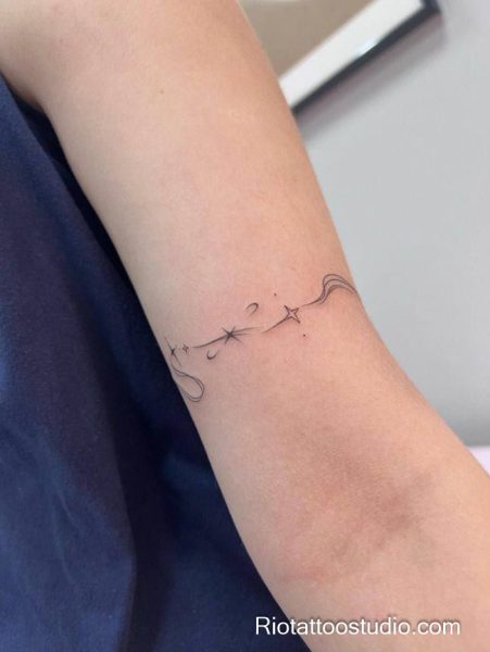 Minimal constellation star tattoo with dots on inner arm, small celestial star tattoo