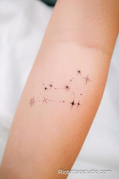Shooting star trail with moon and stars tattoo on forearm, feminine star tattoo