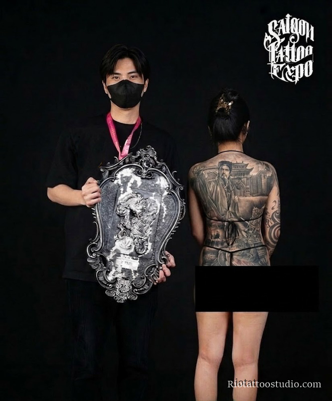 Tattoo Artist Anh Thang receiving an award for a realistic full back tattoo at Saigon Tattoo Convention