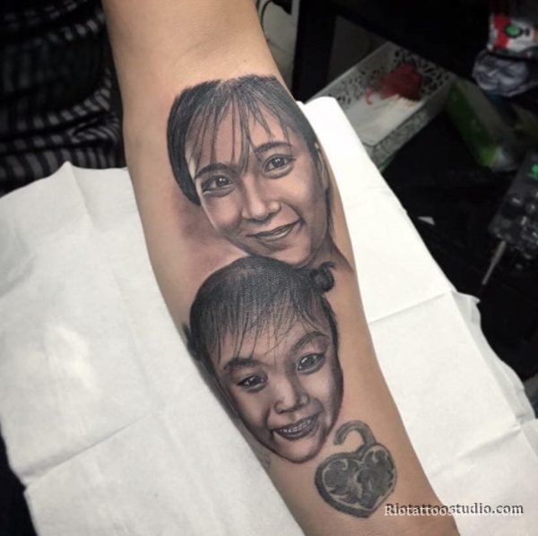 Realistic black and grey portrait tattoo of a wife and daughter, showcasing sentimental family Tattoo Ideas at Rio Tattoo Studio.