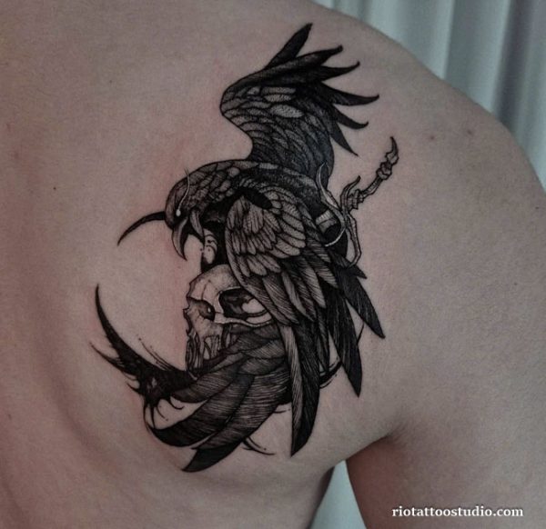 Crow tattoo with skull and sword on shoulder, dark realistic crow tattoo ideas