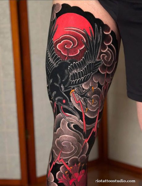 Japanese style crow tattoo with red moon, clouds and lightning on thigh, irezumi crow tattoo ideas