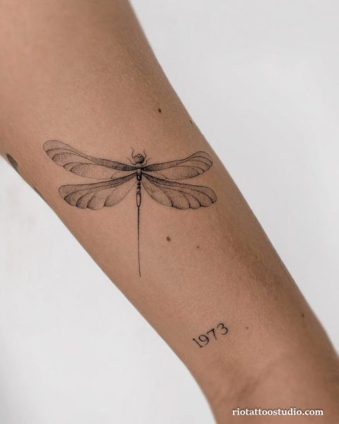Fineline dragonfly "1973" script forearm tattoo, meaningful dragonfly tattoo