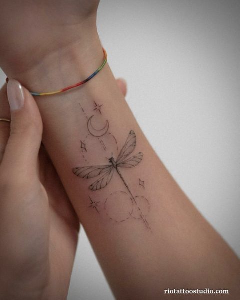 Fineline dragonfly moon stars circles wrist tattoo, cosmic dragonfly tattoo