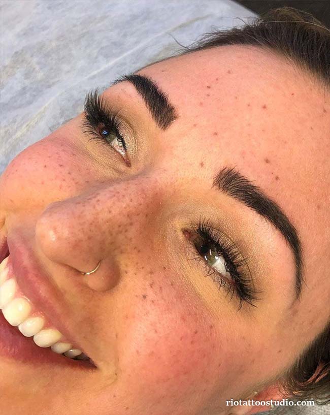 A meaningful hidden word tattoo blended with natural freckles and tattoos.