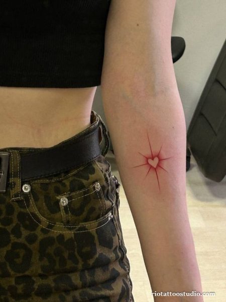 Cracked glowing heart upper arm tattoo red starburst, edgy heart tattoo