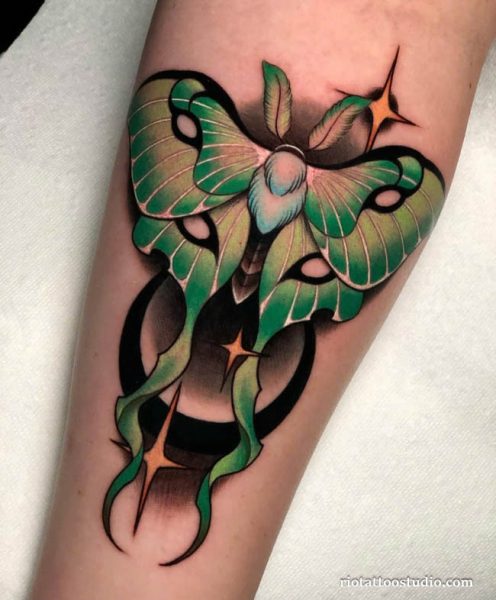 Green luna moth tattoo with stars and crescent on arm, mystical moth tattoo ideas