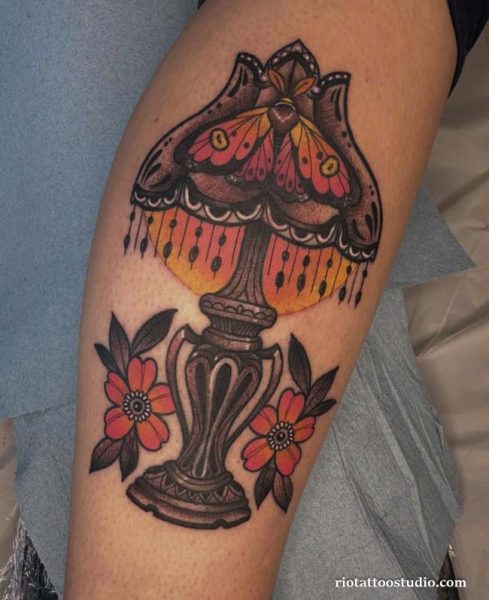 Moth tattoo inside vintage lamp with flowers on arm, unique moth tattoo ideas