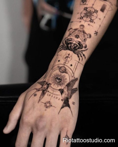 Patchwork forearm hand tattoo crab sun eye swallows planets, cosmic patchwork tattoo