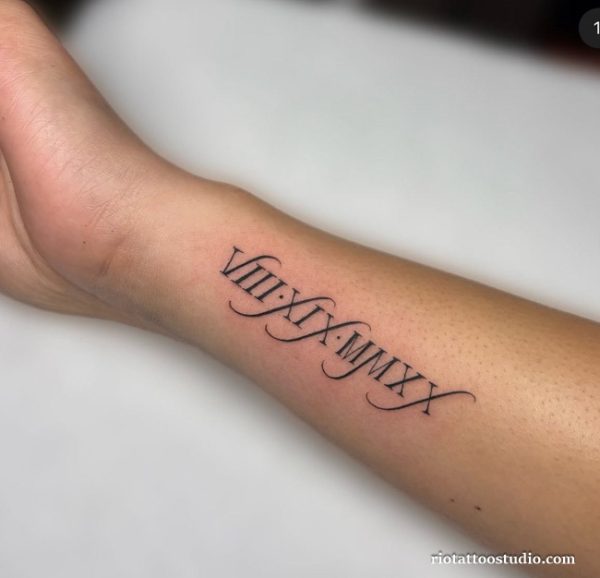 Elegant roman numeral tattoo VIII.IX.MMXX on forearm, fine line roman letter tattoo ideas