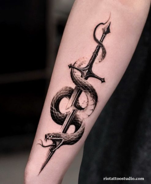 Sword wrapped by aggressive snake tattoo on forearm, sword and serpent tattoo ideas