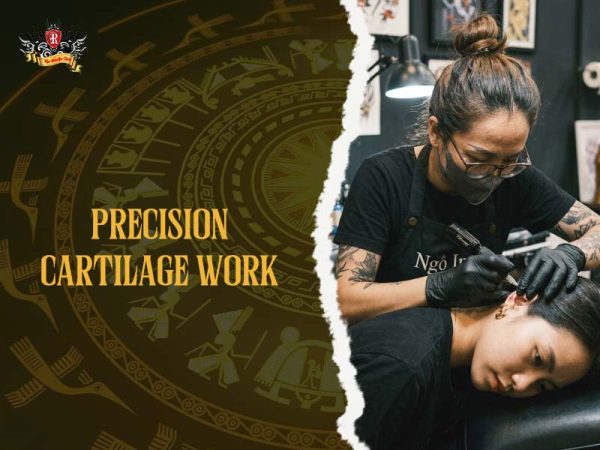 Female artist doing precise cartilage tattoo in ears at Rio Tattoo Studio, professional ear tattoo process