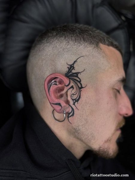 Tribal black ear tattoos behind the ear on a faded haircut, edgy ear tattoos ideas