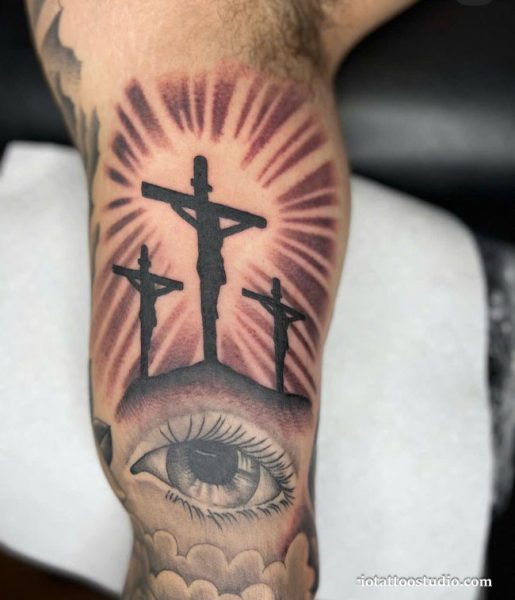 Three crosses tattoo realistic Jesus crucifixion arm sunburst eye, biblical three crosses tattoo