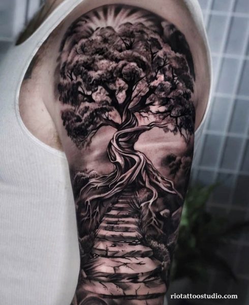 Large shoulder tree tattoo with twisted trunk, stone stairs and dramatic sky, epic tree tattoo sleeve