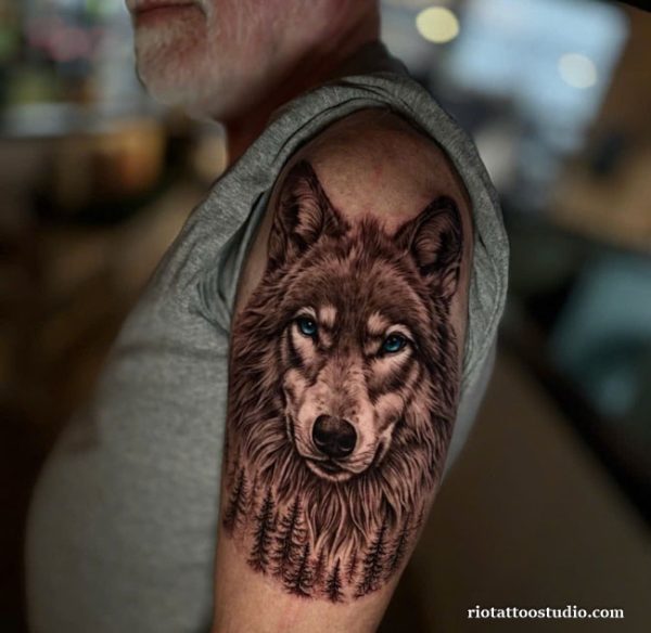 Realistic wolf blue eyes forest mane shoulder arm tattoo, majestic wolf tattoo