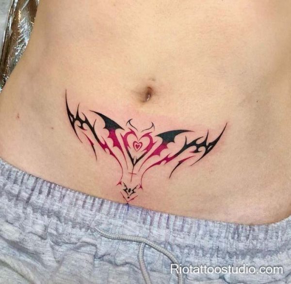 Womb tattoo black pink tribal heart lower abdomen, bold feminine womb tattoo ideas