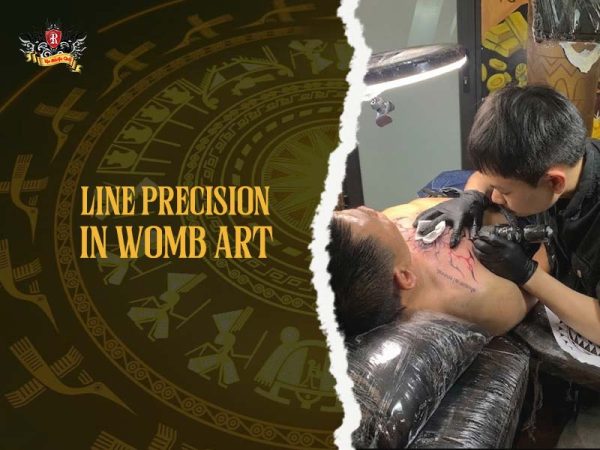 Womb tattoo process artist inking red linework lower stomach, professional womb tattoo session