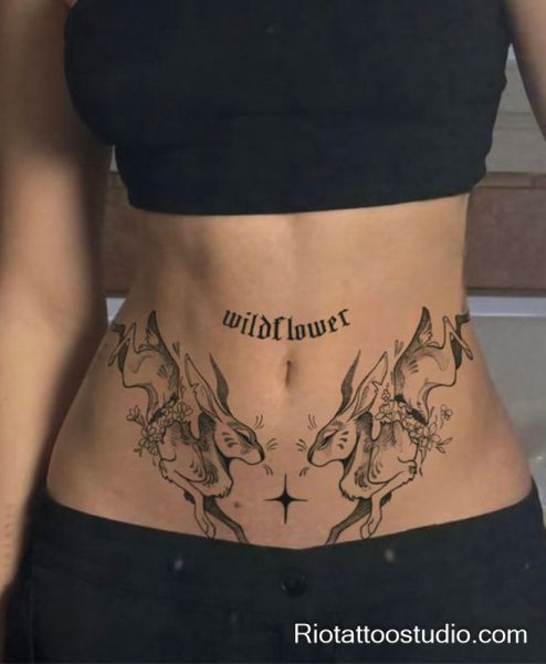 Womb tattoo black hares wildflower text lower stomach, feminine womb tattoo ideas