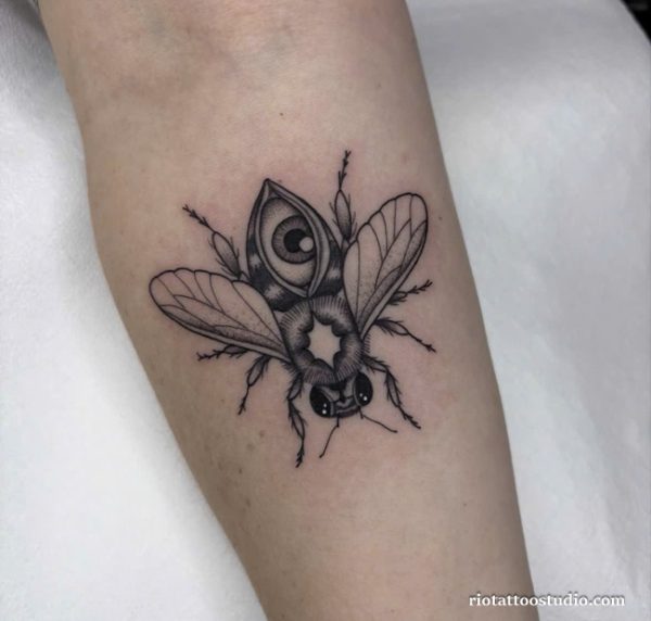 Surreal bee tattoo with third eye and geometric details on forearm, unique bee tattoo ideas