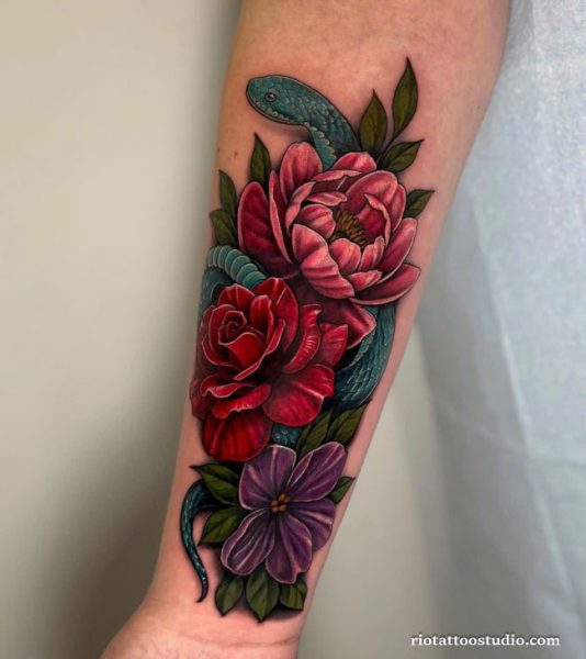 Realistic birth flower tattoo with red peony, rose, purple flower and green snake on forearm