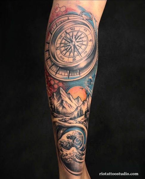 Colorful compass tattoo sleeve with mountains, ocean waves and sunset on leg or arm
