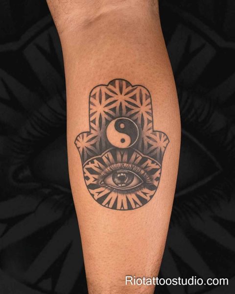 Hamsa hand evil eye tattoo with yin yang symbol and geometric patterns on forearm, evil eye tattoo ideas