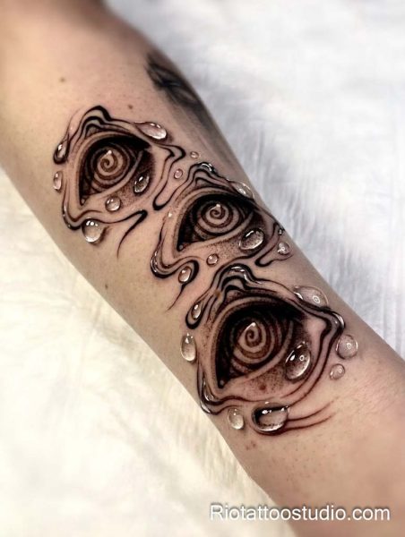 Melting triple evil eye tattoo with water droplets and swirling patterns on arm, evil eye tattoo ideas