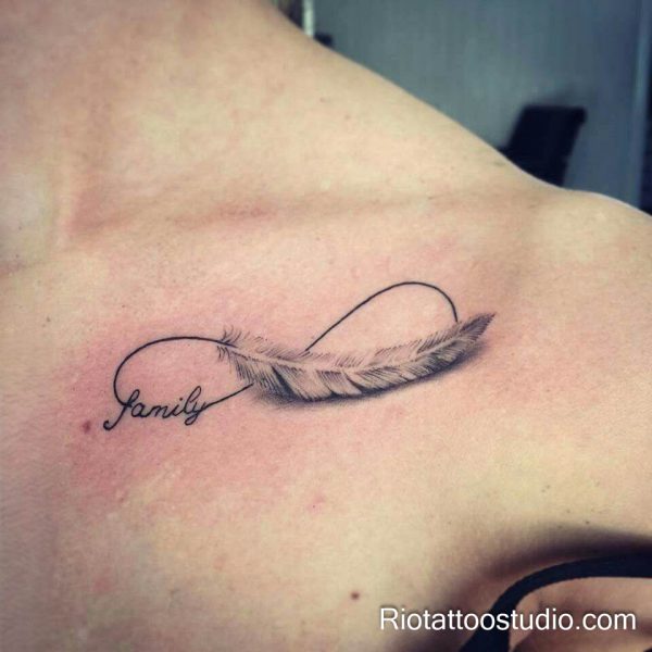 Infinity feather tattoo with "Family" script on shoulder, meaningful family feather tattoo ideas