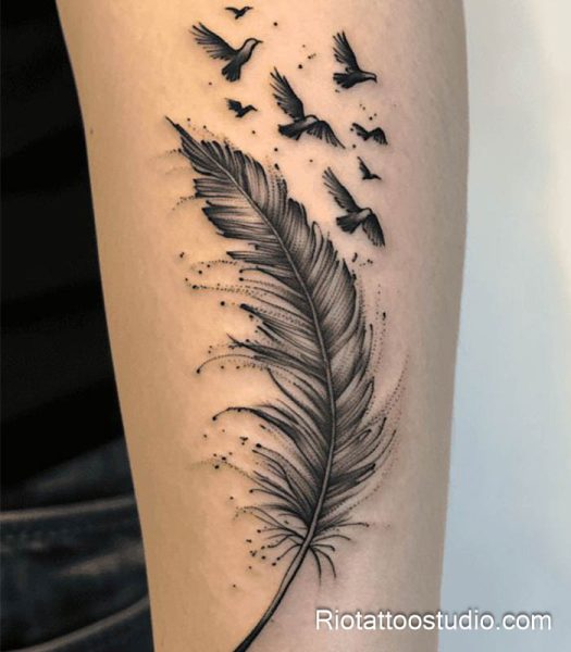 Black and gray feather tattoo with flock of birds on arm, realistic feather tattoo ideas