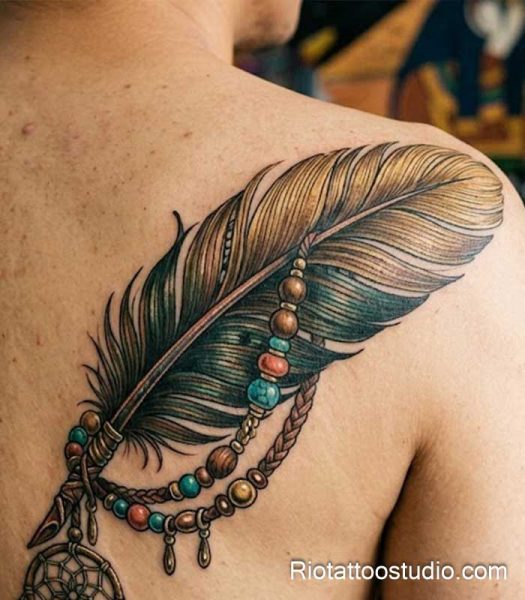 Realistic dreamcatcher feather tattoo with beads and woven details on shoulder, boho feather tattoo ideas