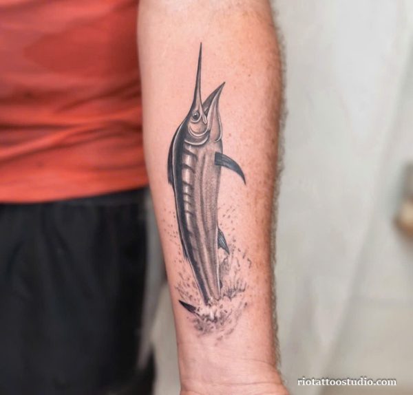 Realistic black and grey swordfish jumping from water tattoo on forearm, cool fish tattoo ideas